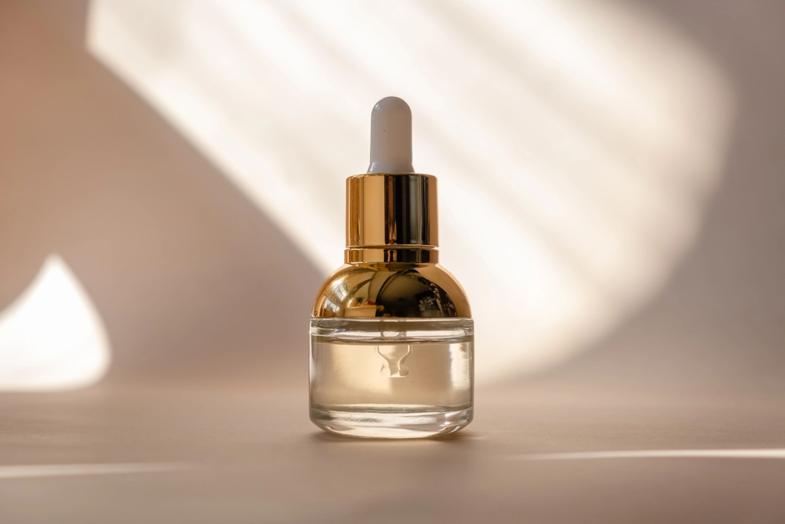 Amber glass skincare serum bottles on a clean surface