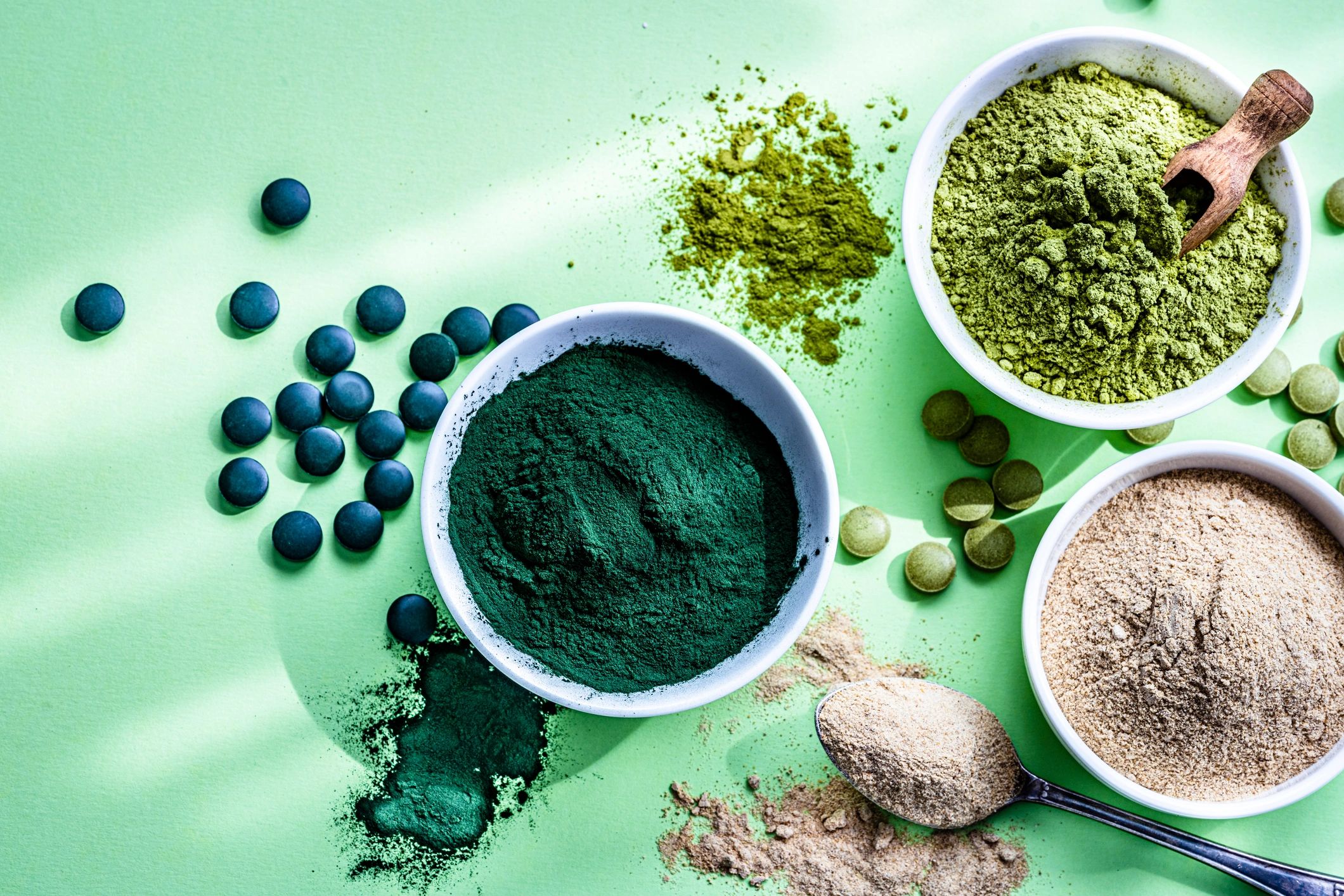 Clean wellness supplements styled on a green background