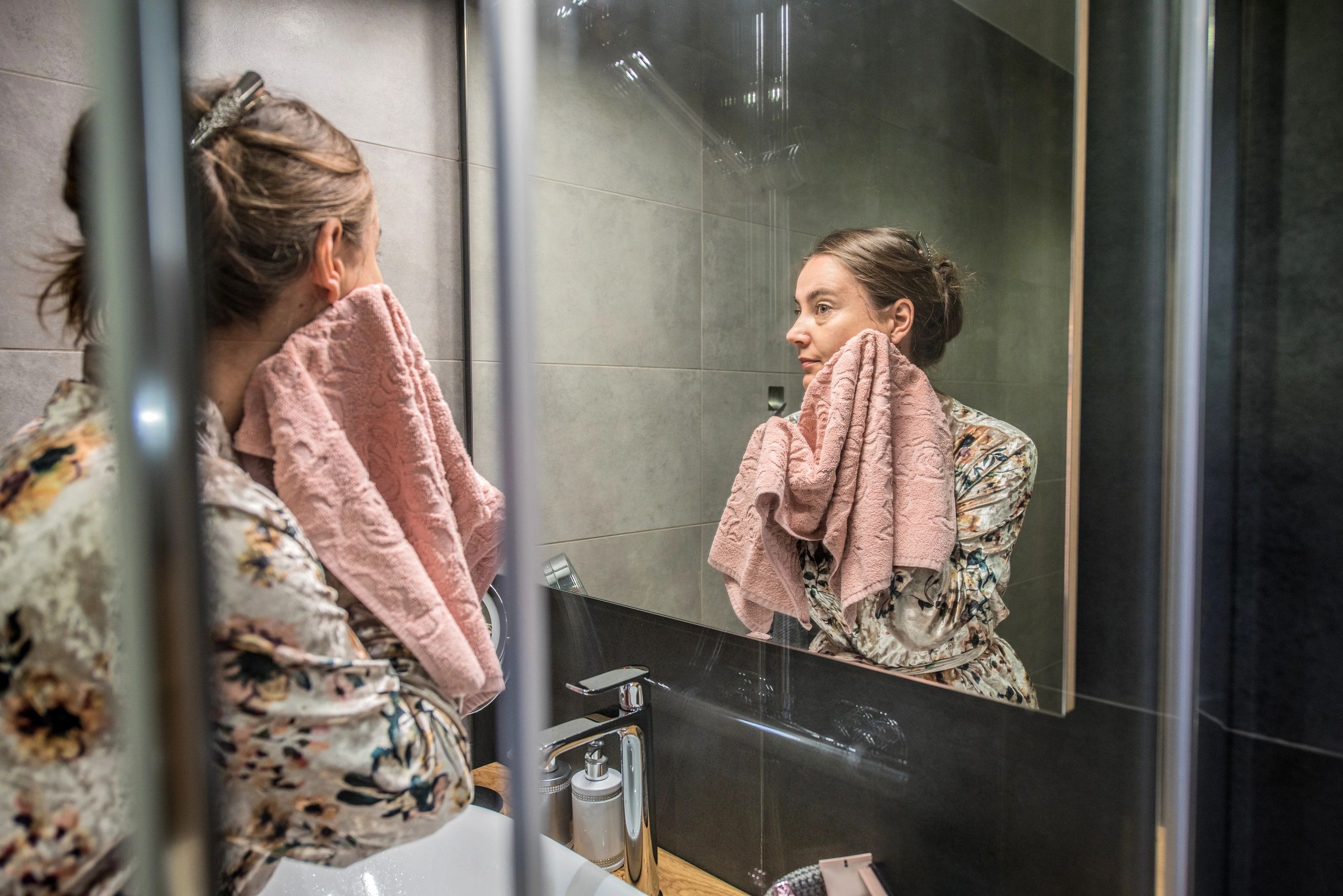 Woman in bathrobe during evening skincare routine
