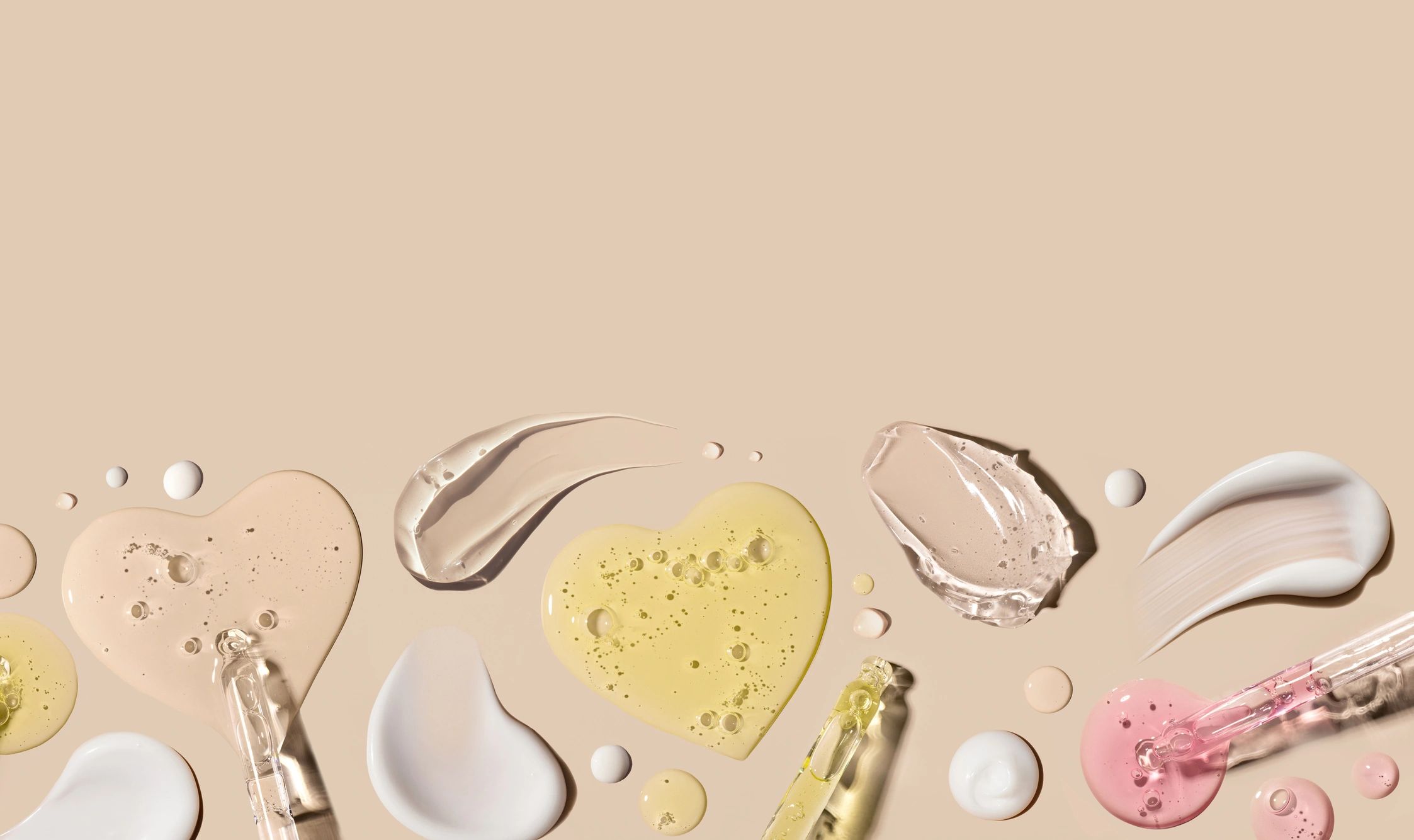 Cosmetic cream textures on a neutral editorial background