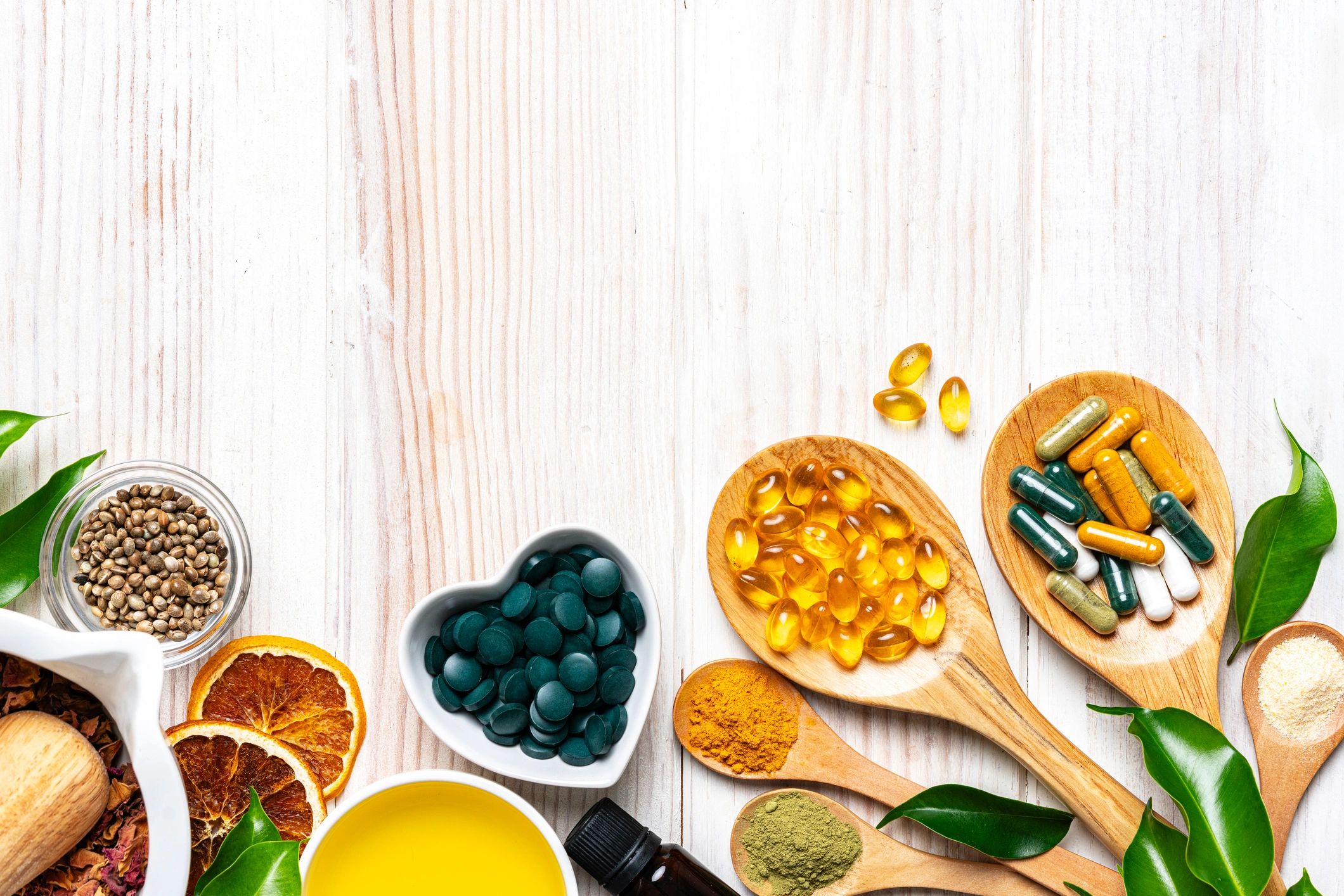 Flat lay of nutritional supplements and wellness capsules on a clean white surface