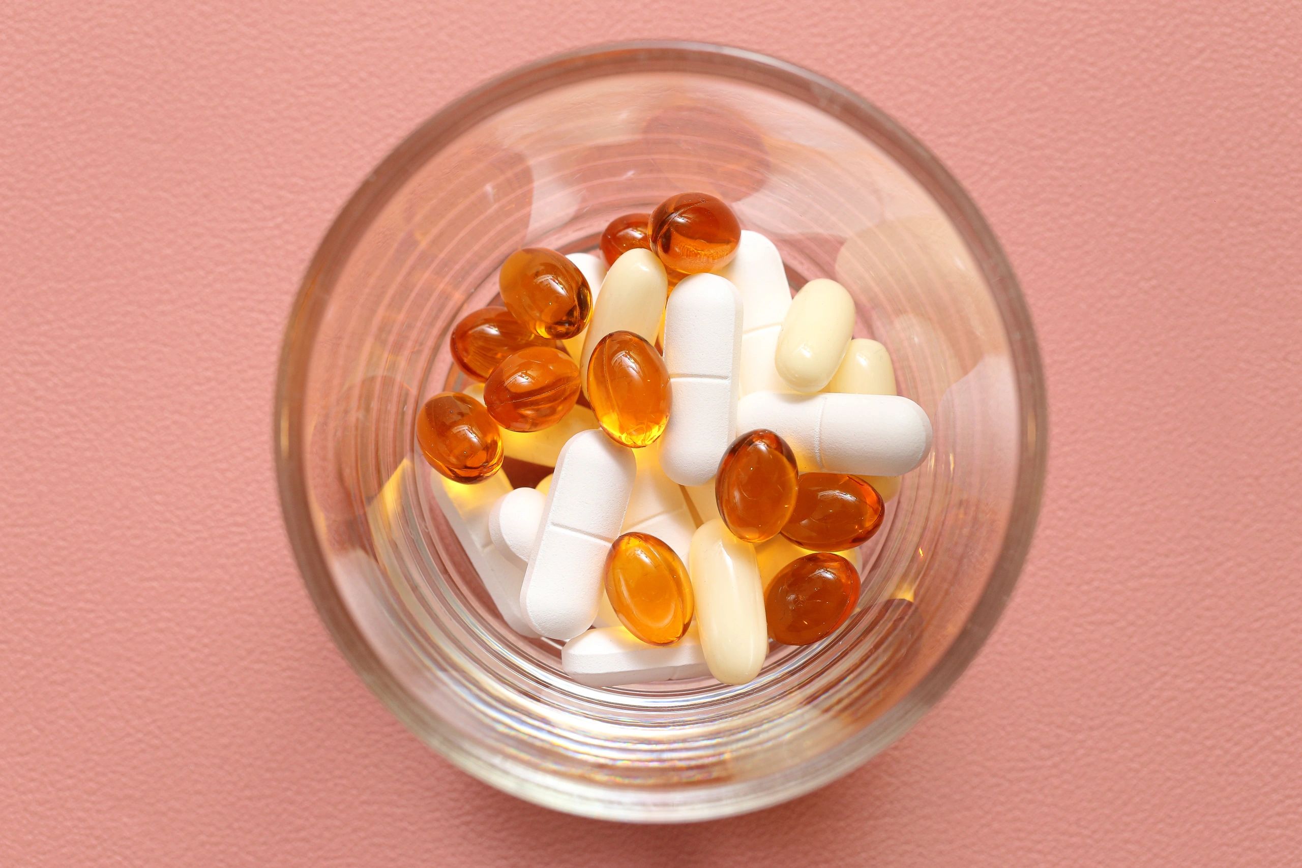 Vitamins and supplements displayed in a glass bowl