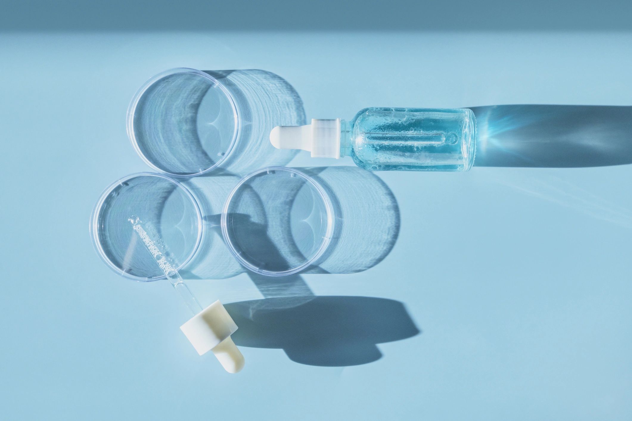 Skincare serum bottle and lab-inspired beauty editorial scene