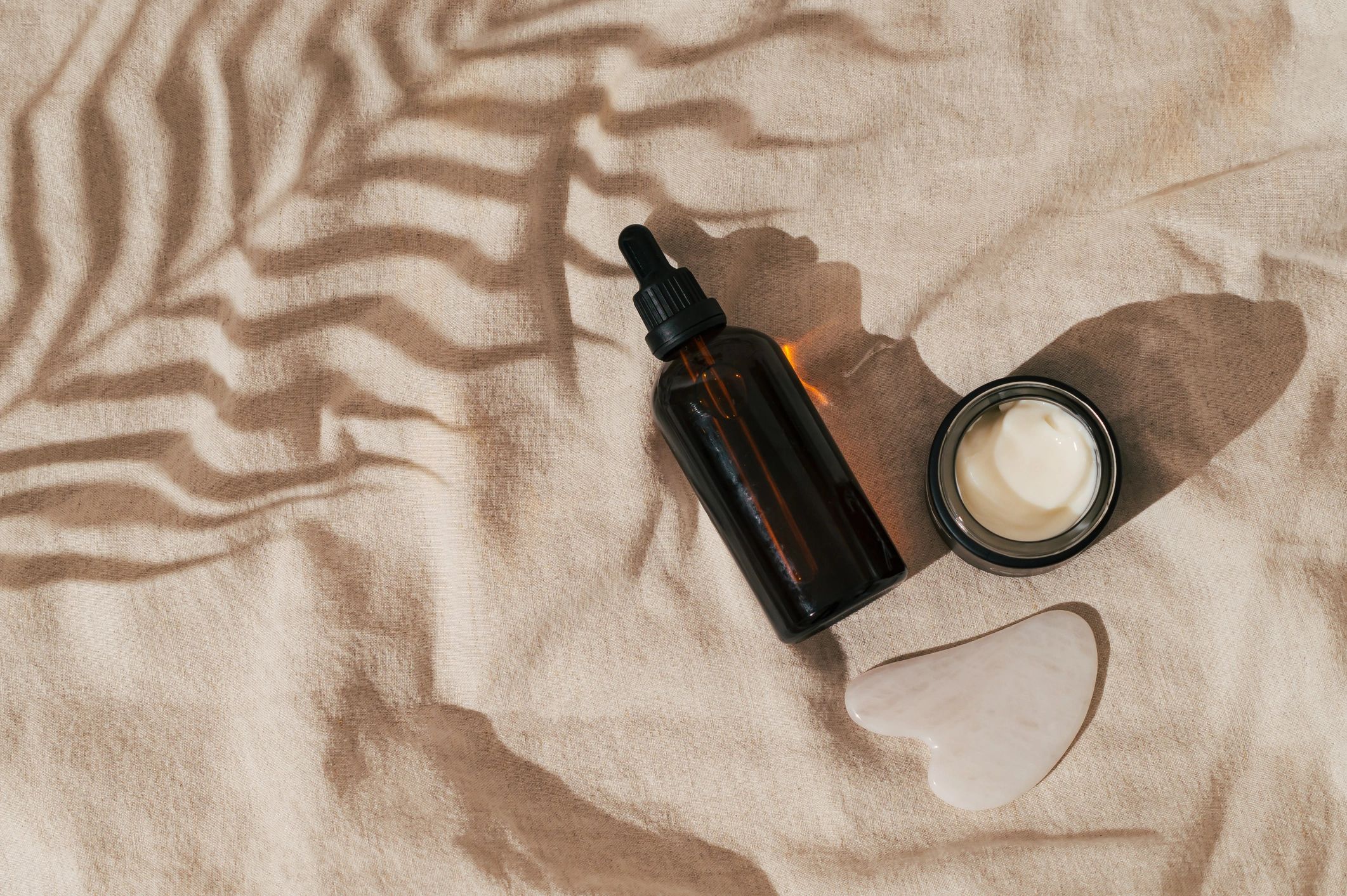 Luxury skincare products arranged in a clean editorial flat lay